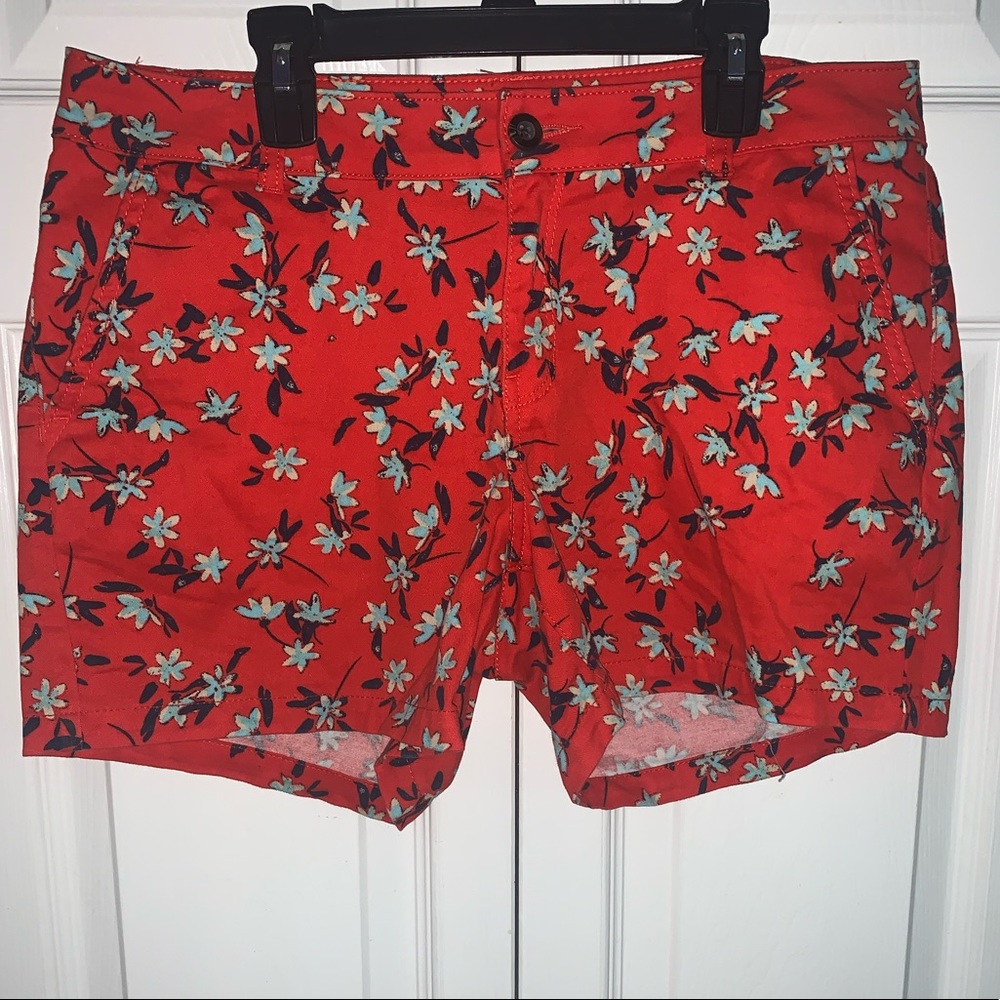 Red shorts with teal and navy flowers